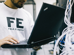 networking staff doing a diagnostic on his laptop
